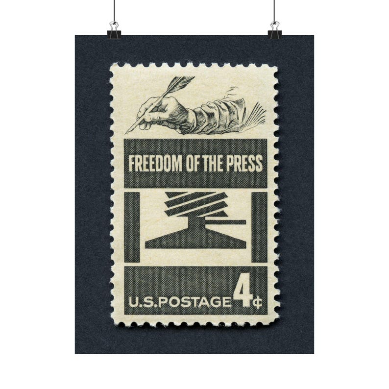 May include: A vintage US postage stamp with a 4-cent denomination. The stamp features a black and white illustration of a hand holding a quill pen, writing on a printing press. The text "FREEDOM OF THE PRESS" is printed in black on a white background.