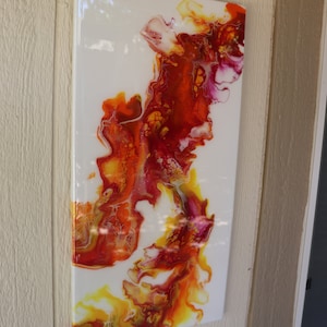 May include: Abstract painting with swirling patterns in shades of red, orange, yellow, and white on a white canvas.
