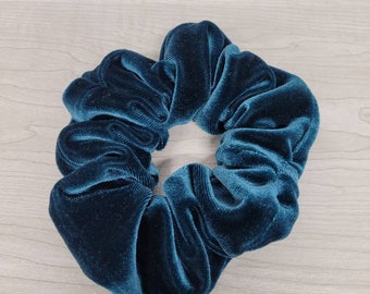 May include: Teal blue velvet scrunchie hair tie.