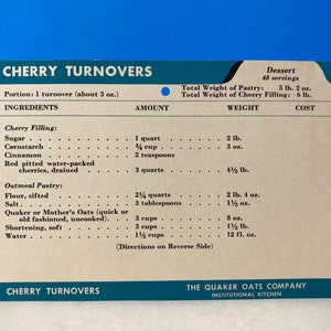 May include: A vintage recipe card for Cherry Turnovers, with instructions for making the cherry filling and oatmeal pastry. The card lists ingredients, amounts, weights, and costs for each ingredient. The card is printed on a light brown background with blue text and a blue border.