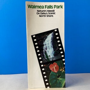 May include: A brochure for Waimea Falls Park on Oahu's North Shore, Hawaii. The brochure features a photo of a waterfall and a red flower.