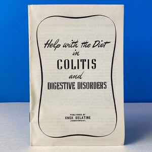 May include: A vintage booklet titled "Help with the Diet in Colitis and Digestive Disorders." The cover is cream-colored with black text and a decorative border. Published by Knox Gelatine, Johnstown, N.Y. The background is a solid blue.