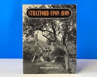 May include: A vintage book cover with a black and white photograph of a thatched-roof building surrounded by trees. The title "STRATFORD-UPON-AVON" is in a gold oval at the top. The author's name, Levi Fox MA., F.S.A., is at the bottom.