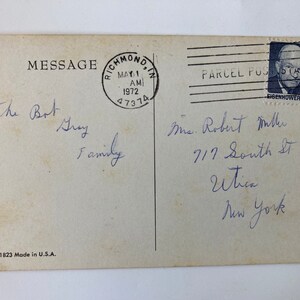 May include: Vintage postcard with handwritten message and address. The postcard has a postmark from Richmond, IN, dated May 1, 1972. A postage stamp featuring Eisenhower is in the upper right corner. The postcard is marked "CRG 1823 Made in U.S.A."