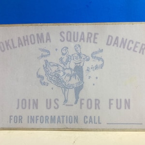 May include: A white card with the text "Oklahoma Square Dancer" and "Join Us For Fun" in blue lettering. The card also has a black and white illustration of a couple square dancing.
