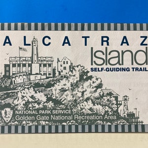 May include: A black and white illustration of Alcatraz Island with the text "Alcatraz Island Self-Guiding Trail" and "National Park Service Golden Gate National Recreation Area".