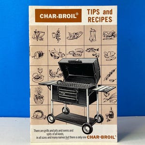 May include: A vintage Char-Broil brochure with the text "TIPS and RECIPES" and a black and white illustration of a grill. The brochure features various food illustrations and the text "There are grills and pits and ovens and spits of all kinds, in all sizes and many names but there is only one CHAR-BROIL."