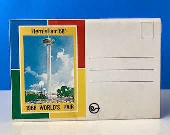 May include: A vintage postcard featuring a colorful illustration of the 1968 World's Fair in Seattle, Washington. The postcard features the iconic Space Needle and the text "HemisFair '68" and "1968 World's Fair".