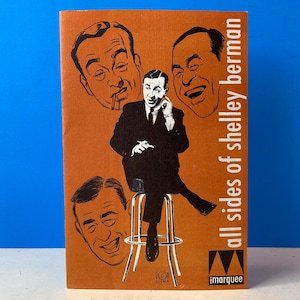 May include: A vintage record album cover featuring a black and white illustration of a man in a suit and tie. The album cover is brown with white text that reads "all sides of shelley berman" and "marquee".