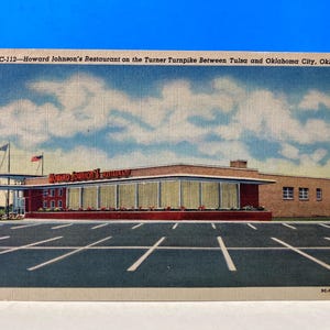 May include: A vintage postcard featuring a Howard Johnson's restaurant on the Turner Turnpike between Tulsa and Oklahoma City, Oklahoma. The building is a single-story structure with a red roof and large windows. The restaurant is surrounded by a parking lot with white lines.