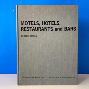 May include: A green book titled "Motels, Hotels, Restaurants and Bars" with the words "Second Edition" and "An Architectural Record Book Published by F.W. Dodge Corporation" printed on the cover.