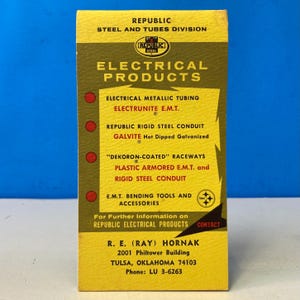 May include: A vintage yellow and brown Republic Steel Electrical Products advertisement. The card lists various electrical products, including metallic tubing and rigid steel conduit. The text includes contact information for R.E. (Ray) Hornak in Tulsa, Oklahoma.