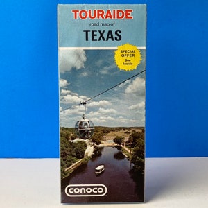 May include: A vintage Touraide road map of Texas with a Conoco logo. The map features a photo of a gondola ride over a river with a blue sky and white clouds in the background. The map has a special offer inside.