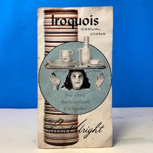 May include: Vintage Iroquois Casual China advertisement. The ad features a stack of plates and a circular illustration of a child with the text "look Mom, no hands!" and "true china that's replaced if it breaks!" The Russell Wright brand is also visible.