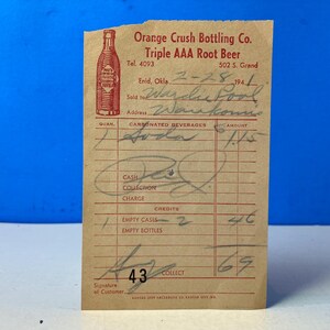 May include: Vintage Orange Crush Bottling Co. receipt from Enid, Oklahoma, dated 2-28-1941. The receipt features a red illustration of an Orange Crush bottle and handwritten details, including the customer's name and the amount.