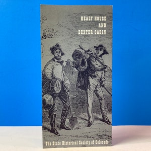 May include: A black and white illustration of two men in period clothing. The men are carrying supplies and tools. The text "Healy House and Dexter Cabin" is printed at the top of the image. The text "The State Historical Society of Colorado" is printed at the bottom of the image.