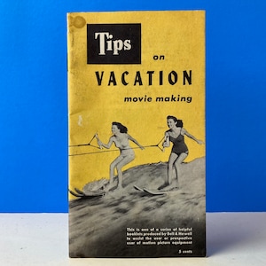 May include: A yellow booklet with the title "Tips on Vacation Movie Making" in black text. The cover features a black and white photo of two women water skiing.