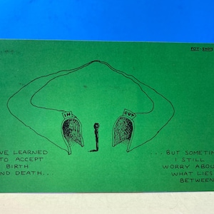 May include: A green postcard with a black ink drawing. The drawing depicts two open doorways labeled "IN" and "OUT", connected by a curved line. Text on the card reads "I've learned to accept birth and death... but sometimes I still worry about what lies between."