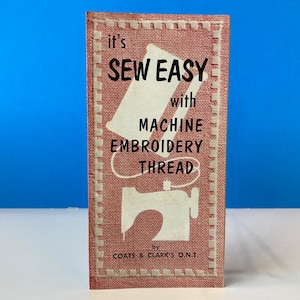 May include: A pink and white booklet with the title "It's Sew Easy with Machine Embroidery Thread" by Coats & Clark's O.N.T. The booklet features a stylized illustration of a sewing machine.