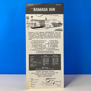 May include: A black and white vintage advertisement for the Ramada Inn in Phoenix, Arizona. The ad features a photo of the hotel building and lists amenities such as a heated Olympic pool, putting green, and free airport limousine service. The ad also includes a rate sheet for different room types.