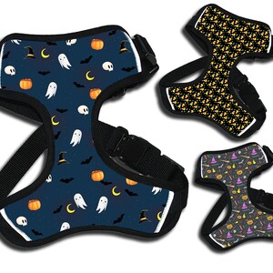 May include: Three different Halloween-themed dog harnesses. The first harness is blue with a pattern of ghosts, pumpkins, bats, and witch hats. The second harness is black with a pattern of orange and yellow candy corn. The third harness is black with a pattern of purple, orange, and green Halloween-themed icons.