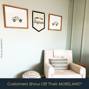 May include: A nursery room with a white rocking chair, a light green wall, and three framed prints. The prints feature a vintage truck and the text "Long Live Boyhood".