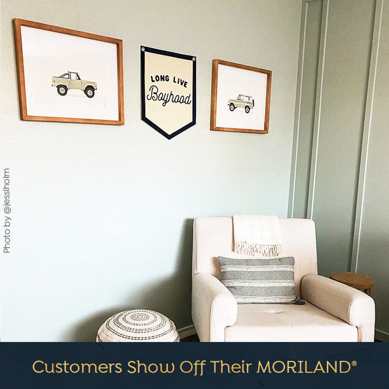 May include: A nursery room with a white rocking chair, a light green wall, and three framed prints. The prints feature a vintage truck and the text "Long Live Boyhood".