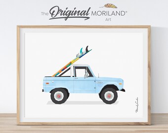 May include: A light blue vintage Ford Bronco pickup truck with a surfboard strapped to the roof. The truck is on a white background.