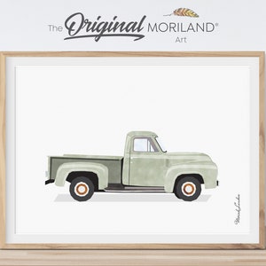 May include: A watercolour illustration of a vintage green pickup truck on a white background. The truck has a white cab and bed, and the wheels are brown with orange centres. The truck is facing to the right, and the illustration is signed "Moriland Art" in the bottom right corner.