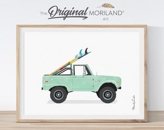 May include: A framed art print featuring a light green vintage pickup truck with a colorful surfboard on top. The artwork includes the text "The Original Moriland Art" at the top and the artist's signature at the bottom.