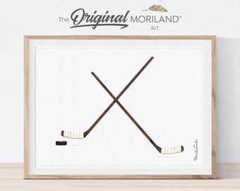 May include: Two crossed hockey sticks with a puck in the center. The sticks are brown with white tape on the blades. The background is white.