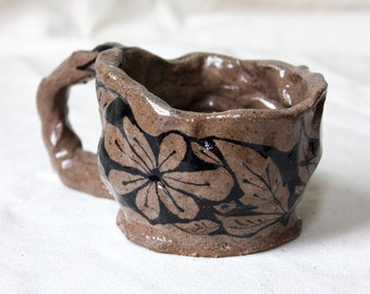 Black Floral Illustrated Mug on Brown Clay