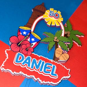 May include: A layered paper cake topper with a Puerto Rican theme. It features a red and white outline of the island, the name "DANIEL", red hibiscus flowers, drums, palm trees, and a "50" sunburst design. The background is red and blue.