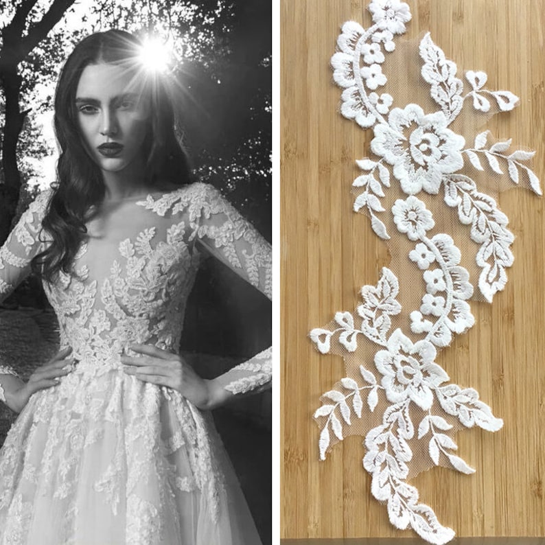 May include: White lace trim with floral designs. The lace is delicate and intricate, with small flowers and leaves. It is perfect for adding a touch of elegance to any project.