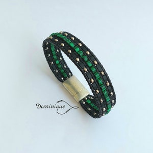 May include: A black leather bracelet with green and silver beads. The bracelet has a magnetic clasp.