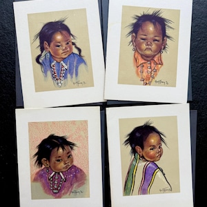 May include: Set of four art prints featuring portraits of children with dark hair and skin, each wearing colorful clothing and jewelry. The artwork is on cream-colored paper, mounted on dark blue cardstock.
