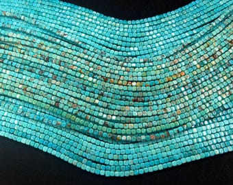 May include: Multiple strands of small, square-shaped turquoise beads arranged in a curved, layered formation. Each bead features a vibrant cyan-blue color with natural brown and dark matrix veining, creating a textured, uniform appearance.