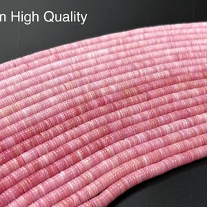 May include: A strand of 6mm high quality pink and white striped round beads. The beads are made of natural materials and have a smooth, polished finish.
