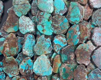 May include: A collection of irregularly shaped turquoise stones with a mix of blue-green and brown hues. The stones vary in size and texture, creating a natural, earthy aesthetic. Ideal for jewelry making or decorative purposes.