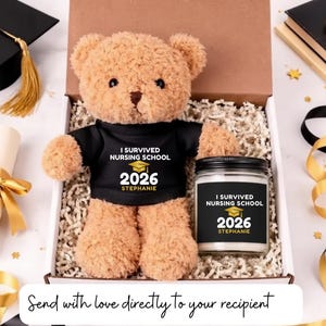 May include: A graduation gift set featuring a plush teddy bear wearing a black t-shirt with "I Survived Nursing School 2026" and a matching candle. The gift box includes decorative paper and ribbons.