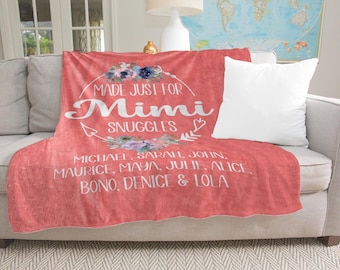 May include: Coral red fleece blanket with a white floral design and the text "Made Just For Mimi Snuggles" with a list of names below.