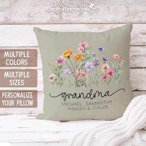 May include: A green throw pillow with a floral design and the text "grandma" with the names "Michael, Samantha, Ashley & Caleb" underneath.