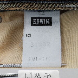 May include: Close-up of denim jeans labels. The top label reads "Miss EDWIN INTERNATIONAL BASIC" in red and white. The middle label indicates size 31x32. The bottom label has Japanese text and care instructions.