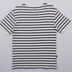 May include: A short-sleeve t-shirt featuring a horizontal striped pattern in navy blue and off-white. The garment has a crew neckline and includes the text "MADE IN USA" printed on the inside collar area, along with a small black tag on the side seam.