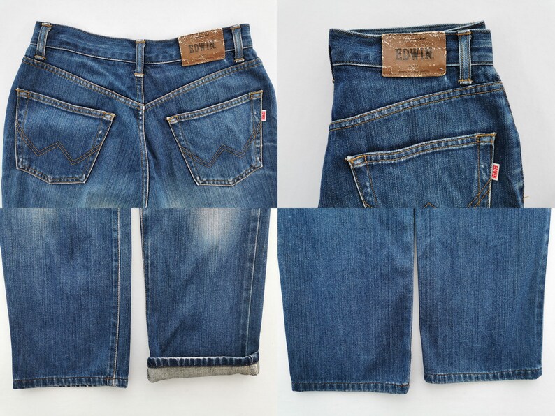 May include: Blue denim jeans with a classic five-pocket design. Features a brown leather patch with "EDWIN" branding on the back waistband. The jeans have a straight leg cut and a red tag on the back pocket.
