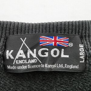 May include: Close-up of a black label from a Kangol England sweatshirt. The label features the Kangol logo, the Union Jack flag, and the text "Made under licence to Kangol Ltd., England." The label also indicates the size is "LARGE."