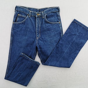 May include: A pair of classic blue denim jeans, featuring a button and zipper closure, front and back pockets, and belt loops. The jeans are folded neatly, showcasing the traditional five-pocket design and a straight leg cut.