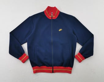 Giacca Nike vintage anni '90, con logo Nike blu e scritta "Swoosh", realizzata in Giappone, taglia L.
