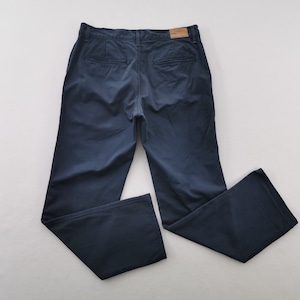 May include: Navy blue pants with a classic design. The pants feature a button and zipper closure, belt loops, and two back pockets. The pants are made of a soft, durable fabric.
