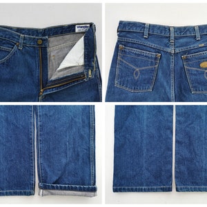May include: Blue denim jeans with a zipper fly and a button closure. The jeans have front and back pockets, and the brand "Wrangler" is visible on the label. The jeans have a straight leg and are cuffed at the bottom.